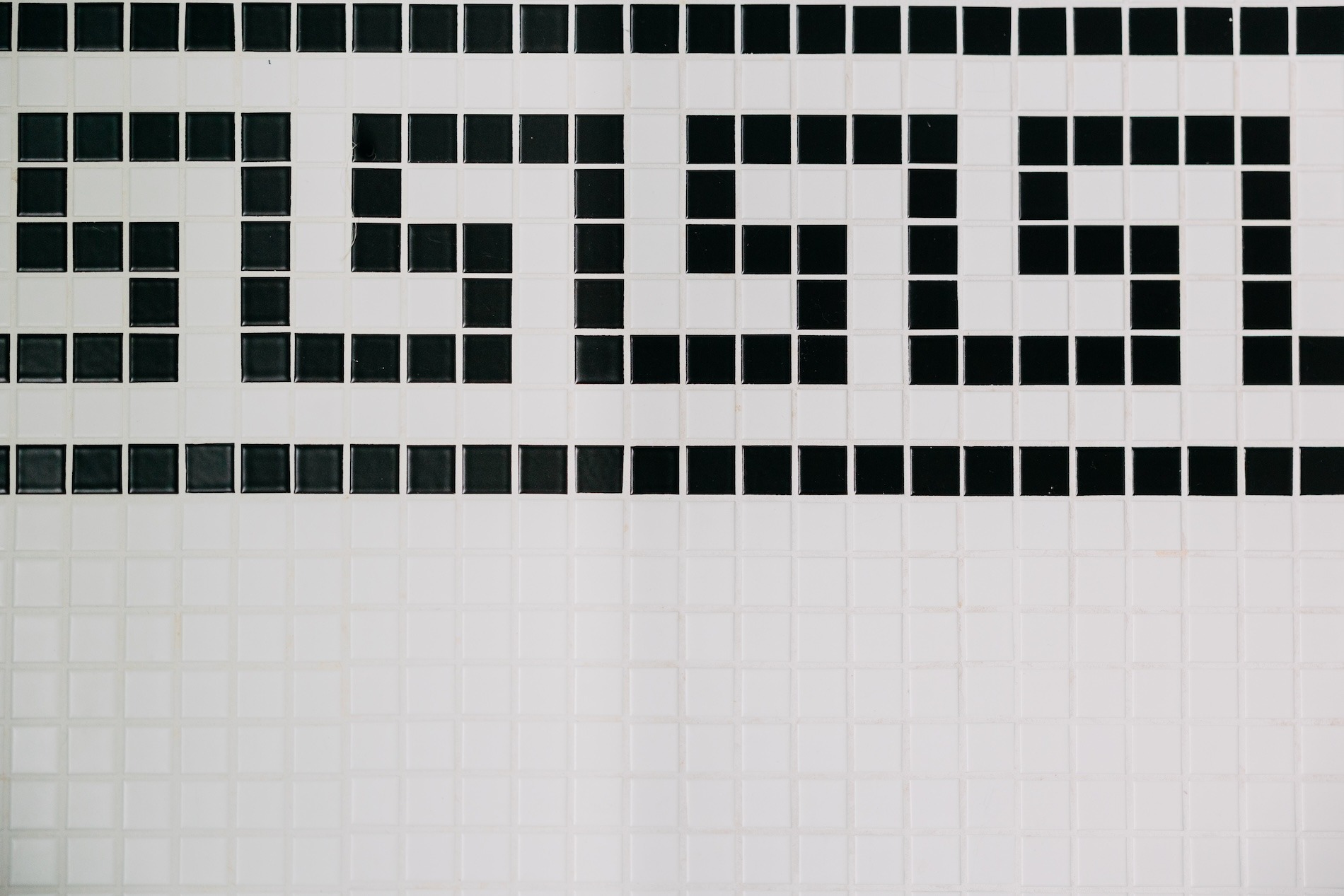 Black Tile Design On White Tile Floor